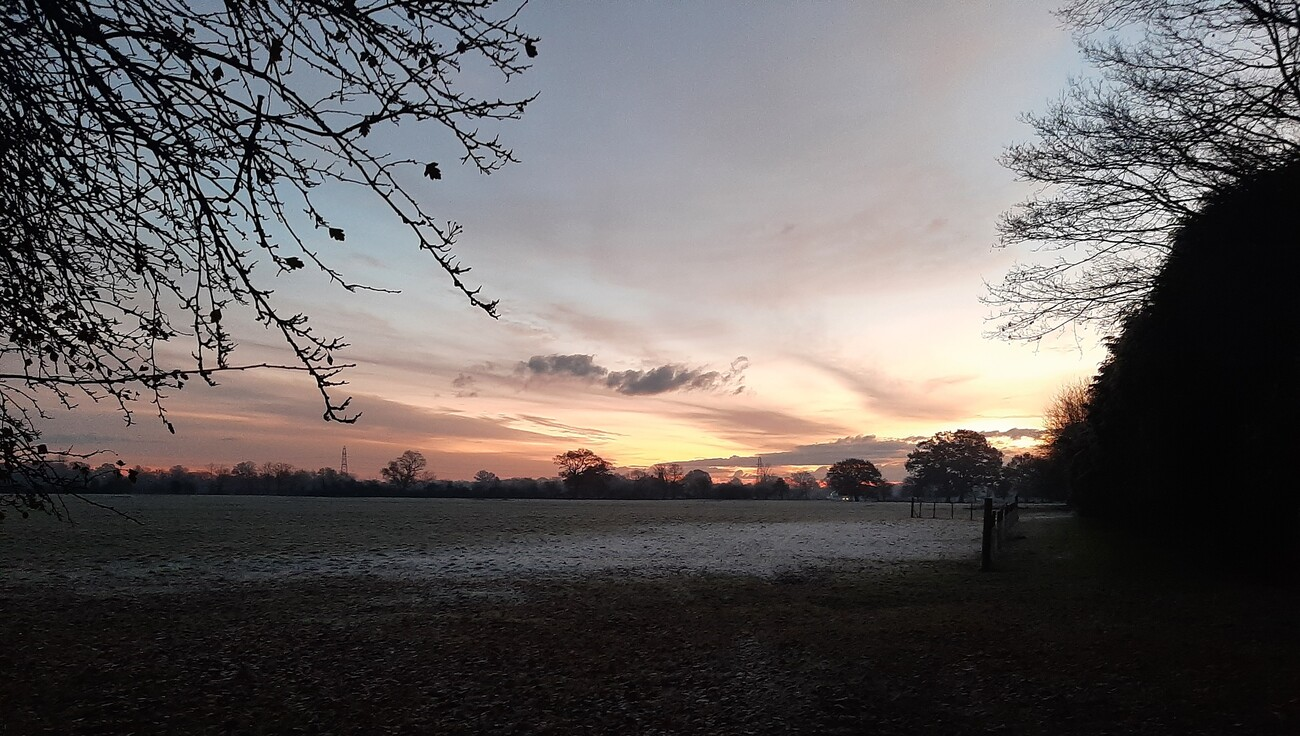 Sunrise over field in English countryside
